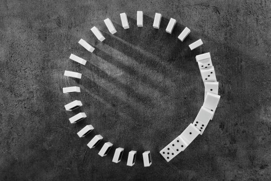 Circle,Of,Dominoes,Standing,On,Gray,Background